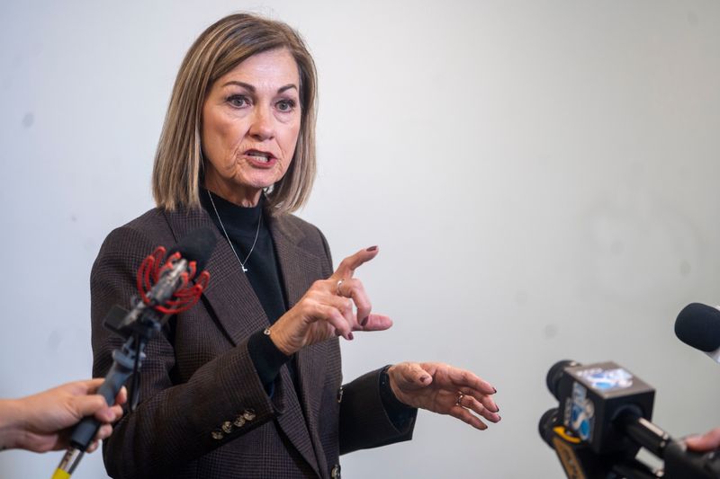 Gov. Kim Reynolds speaks to reporters at the Roy R. Estle Memorial Library on Thursday, Oct. 16, 2025, in Dallas Center.