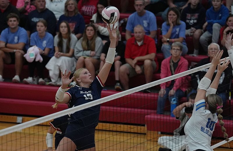 Ballard outside hitter Brenna Baumgardner (1) tips the ball over Bondurant-Farrar's Tenley Fried (10) during the first set of the Bombers' four-set victory in Raccoon River Conference volleyball at Ballard High School on October 16, 2025, in Huxley, Iowa.