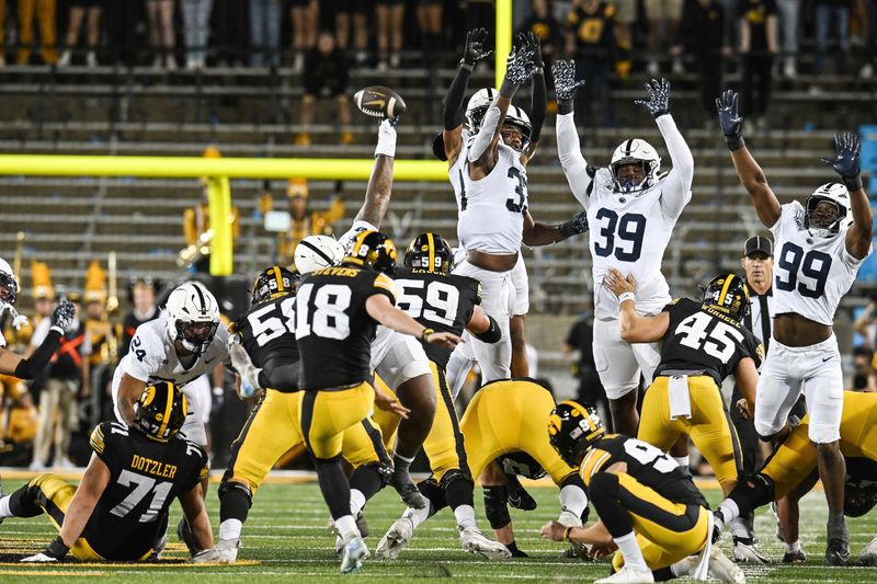 Oct 18, 2025; Iowa City, Iowa, USA; Penn State Nittany Lions defensive tackle Xavier Gilliam (54) blocks the 66 yard field goal attempt of Iowa Hawkeyes kicker Drew Stevens (18) that would lead to a touchdown return for the Nittany Lions on the final play of the second half at Kinnick Stadium. Mandatory Credit: Jeffrey Becker-Imagn Images