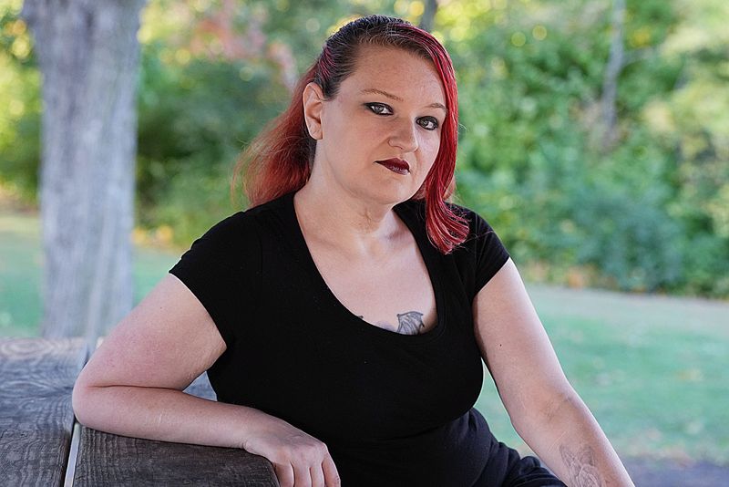 Cassie Lowe from Ames, recipient of Embrace Iowa, poses at the Inis Grove Park in Ames, Iowa.