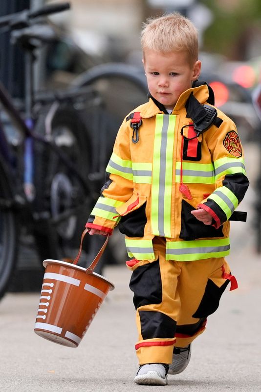 Jack Farley, 2, sprints to the next trick-or-treat spot during a Downtown Iowa City Halloween event Oct. 21, 2025 in Iowa City, Iowa.