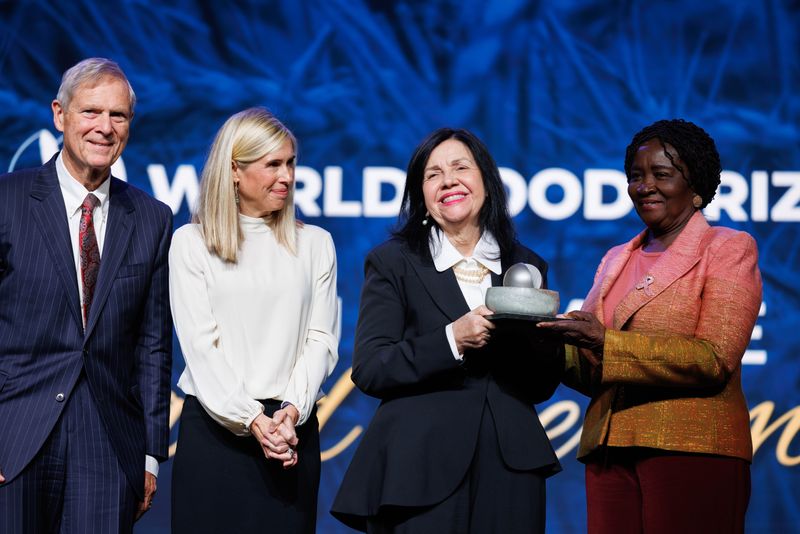 Brazilian scientist Mariangela Hungria accepts the 2025 World Food Prize during a ceremony Thursday, Oct. 23, in Des Moines. With Hungria is Rachel Ruan McLean (left), foundation board vice president; Tom Vilsack, the foundation's CEO, and Jane Naana Opoku-Agyemang, Ghana vice president.