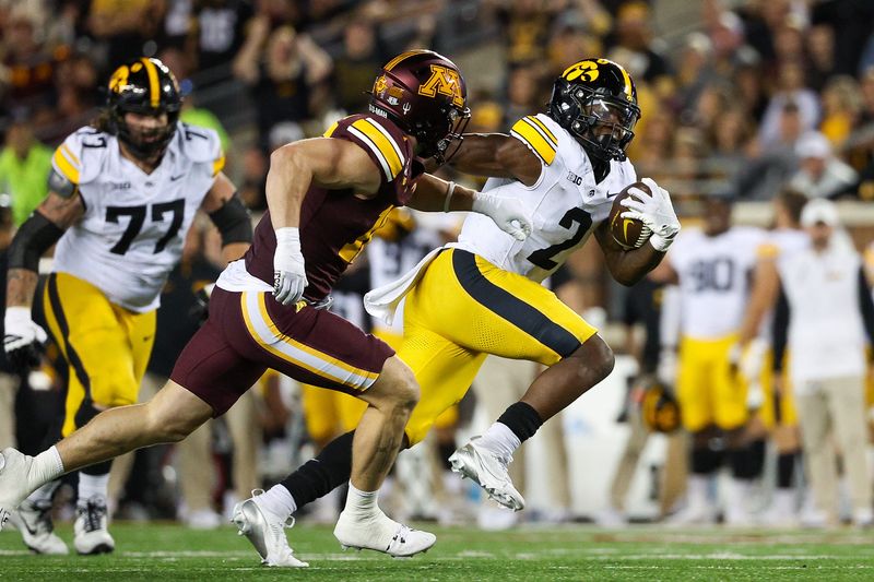 Sep 21, 2024; Minneapolis, Minnesota, USA; Iowa Hawkeyes running back Kaleb Johnson (2) runs the ball resulting in a touchdown as Minnesota Golden Gophers defensive back Coleman Bryson (16) defends during the second half at Huntington Bank Stadium. Mandatory Credit: Matt Krohn-Imagn Images