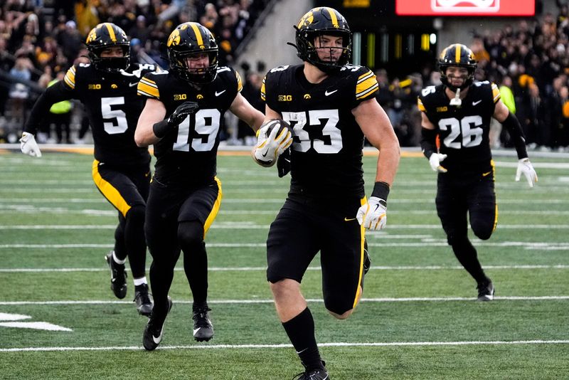 Iowa Hawkeyes linebacker Cam Buffington (33) runs the ball after intercepting a pass during a game against the Minnesota Golden Gophers Oct. 25, 2025 at Kinnick Stadium in Iowa City, Iowa.