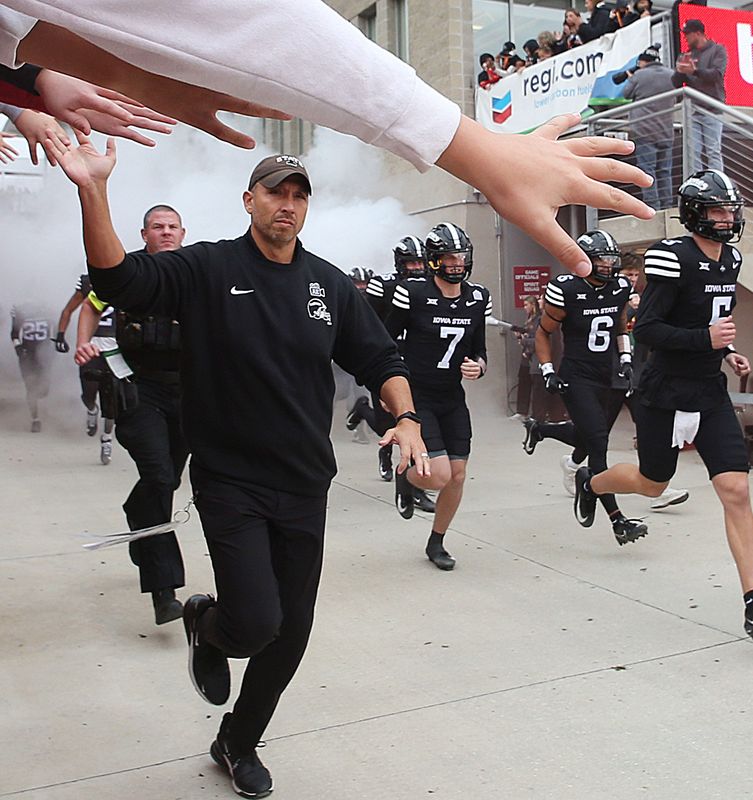 Iowa State football head coach Matt Campbell high-five with fans while leading the team to the field before the game against BYU at Jack Trice Stadium on Oct. 25, 2025, in Ames, Iowa.