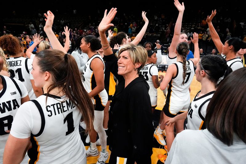 Iowa head coach Jan Jensen and her team wave to the Hawkeye fans Oct. 30, 2025 after defeating the Ashland Eagles in an exhibition game at Carver-Hawkeye Arena in Iowa City, Iowa.