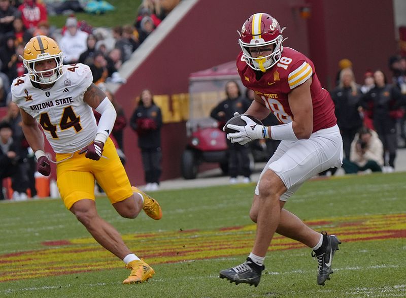 Iowa State Cyclones' tight end Benjamin Brahmer (18) runs with the ball after making a catch ball around Arizona State Sun Devils linebacker Keyshaun Elliott (44) during the first quarter in the Big-12 showdown at jack Trice Stadium on Nov. 1, 2025, in Ames, Iowa.
