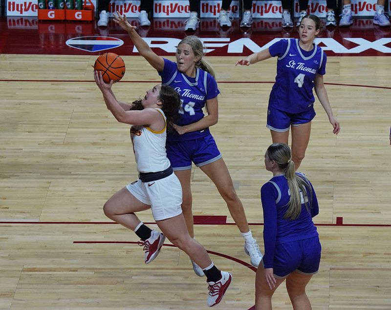 Iowa State  guard Reese Beaty (1) shoots the ball around St. Thomas defenders during the Cyclones' season-opening victory at Hilton Coliseum on Nov. 3.