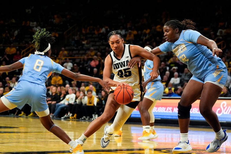 Iowa forward Hannah Stuelke (45) drives to the basket against Southern guard Mykayla Cunningham (8) and Southern center Xyllize Harrison (32) Nov. 3, 2025 during a women’s college basketball game at Carver-Hawkeye Arena in Iowa City, Iowa.