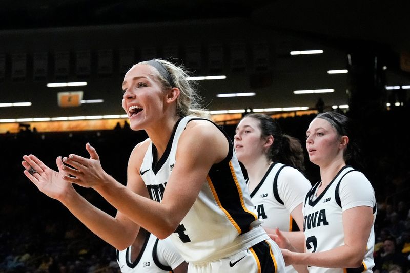 Iowa guard Kylie Feuerbach (4) cheers on her teammates Nov. 3, 2025, during a women's college basketball game against the Southern Jaguars at Carver-Hawkeye Arena in Iowa City, Iowa.