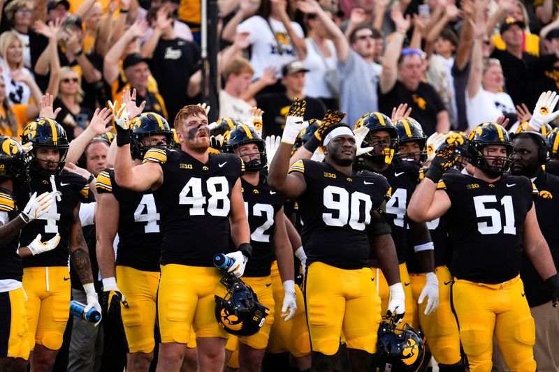 Iowa Hawkeyes football players do the wave after the first quarter against the Albany Great Danes Aug. 30, 2025 at Kinnick Stadium in Iowa City, Iowa.
