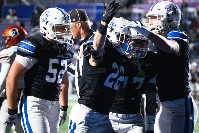 Waukee Northwest's Ryan Woodruff celebrates a touchdown with teammates during 5A playoff football game at Waukee Northwest High School on Friday, Nov. 7, 2025, in Waukee.
