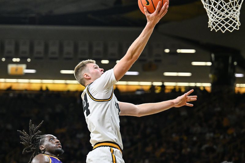 Nov 7, 2025; Iowa City, Iowa, USA; Iowa Hawkeyes guard Bennett Stirtz (14) goes to the basket against the Western Illinois Leathernecks during the second half at Carver-Hawkeye Arena. Mandatory Credit: Jeffrey Becker-Imagn Images