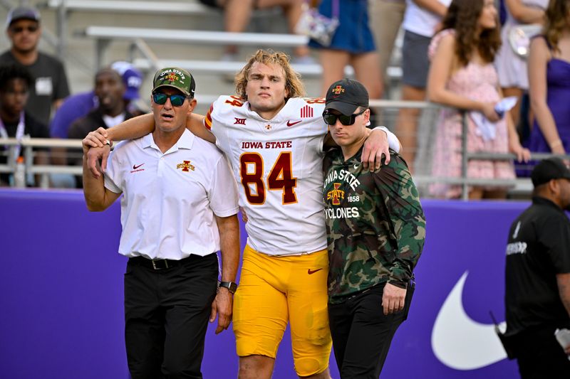 Nov 8, 2025; Fort Worth, Texas, USA; Iowa State Cyclones tight end Gabe Burkle (84) is helped off the field during the first half against the TCU Horned Frogs at Amon G. Carter Stadium. Mandatory Credit: Jerome Miron-Imagn Images