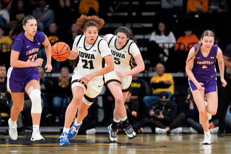 Iowa guard Emely Rodriguez (21) brings the ball down court against the Evansville Purple Aces Nov. 9, 2025 during a women’s basketball game at Carver-Hawkeye Arena in Iowa City, Iowa.