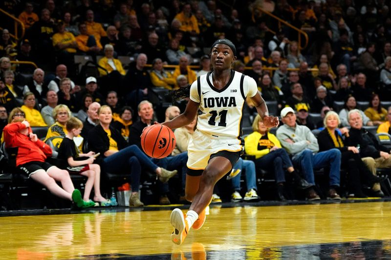 Iowa guard Chit-Chat Wright (11) drives to the basket Nov. 9, 2025 during a women’s basketball game against the Evansville Purple Aces at Carver-Hawkeye Arena in Iowa City, Iowa.
