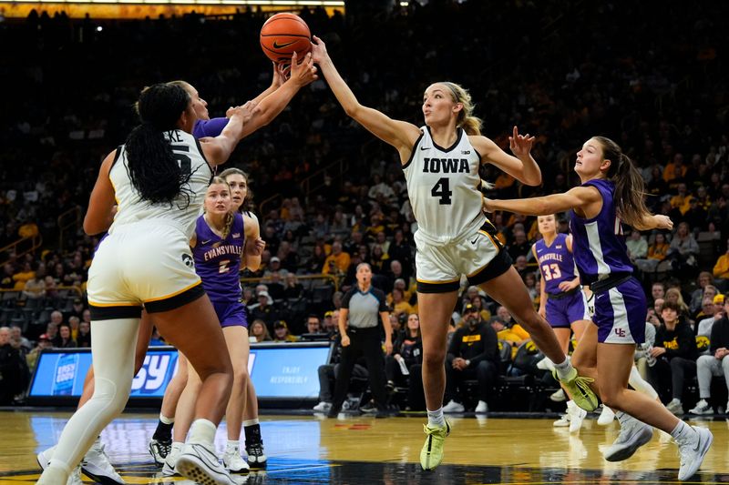 Iowa guard Kylie Feuerbach (4) reaches for the ball Nov. 9, 2025 during a women’s basketball game against the Evansville Purple Aces at Carver-Hawkeye Arena in Iowa City, Iowa.