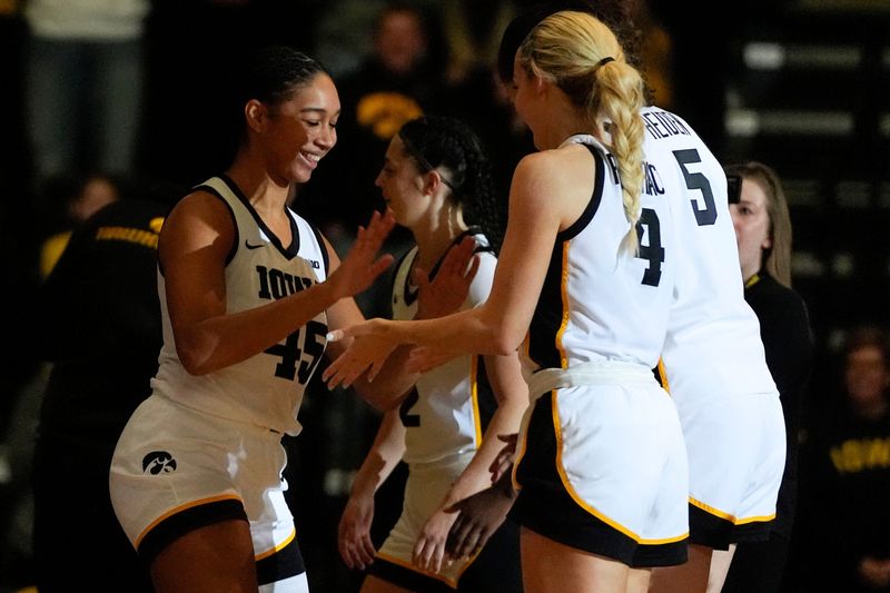 Iowa forward Hannah Stuelke (45) high-fives teammates after being announced in the starting lineup against the Evansville Purple Aces Nov. 9, 2025, during a women's basketball game at Carver-Hawkeye Arena in Iowa City, Iowa.