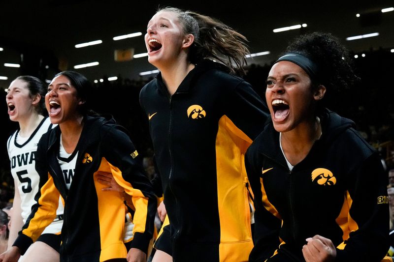 Iowa center Ava Heiden (5), Iowa forward Jada Gyamfi (23), Iowa guard Teagan Mallegni (55), and Iowa guard Kennise Johnson (13) react during a game against the Drake Bulldogs Nov. 13, 2025 at Carver-Hawkeye Arena in Iowa City, Iowa.