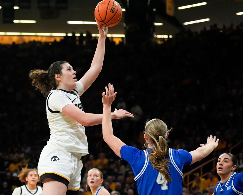 Iowa center Ava Heiden (5) shoots over Drake guard Shannon Fornshell (4) Nov. 13, 2025 at Carver-Hawkeye Arena in Iowa City, Iowa.