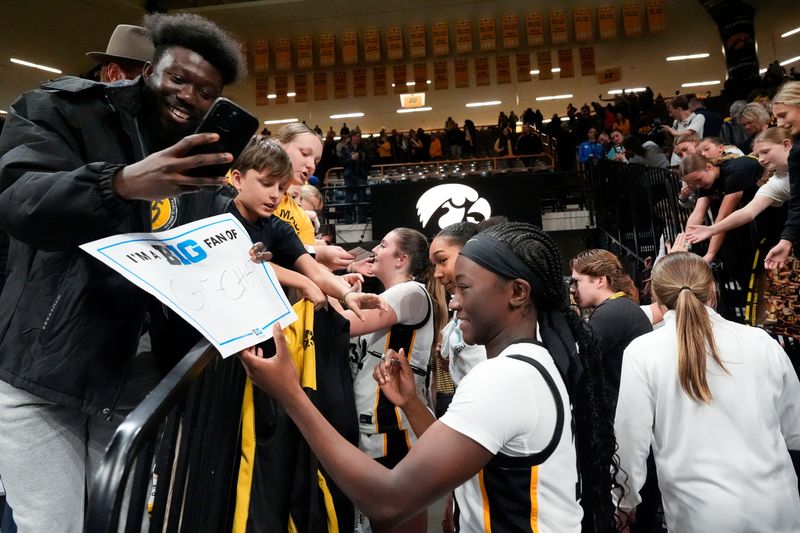 Iowa guard Chit-Chat Wright (11) signs autographs after the Hawkeys’ basketball game against the Drake Bulldogs Nov. 13, 2025 at Carver-Hawkeye Arena in Iowa City, Iowa.