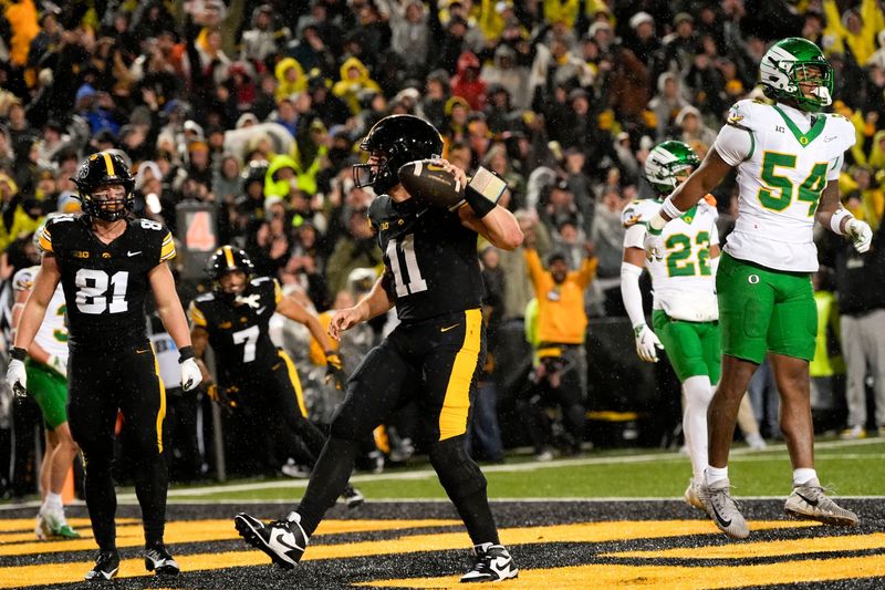 Iowa Hawkeyes quarterback Mark Gronowski (11) scores the go-ahead touchdown in the fourth quarter against the Oregon Ducks Nov. 8, 2025 during a Big Ten Football game at Kinnick Stadium in Iowa City, Iowa.