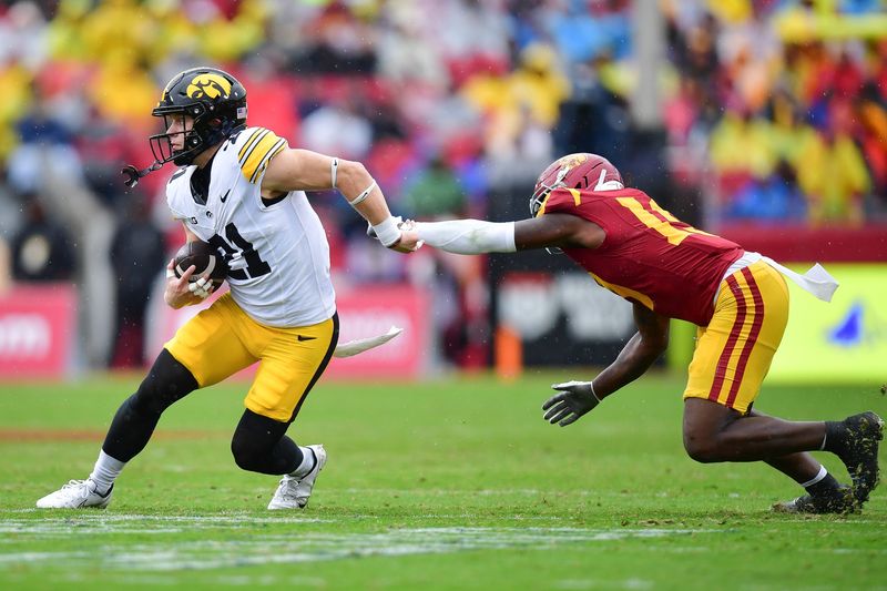 Nov 15, 2025; Los Angeles, California, USA; Iowa Hawkeyes wide receiver Kaden Wetjen (21) runs the ball against Southern California Trojans safety Bishop Fitzgerald (19) during the first half at the Los Angeles Memorial Coliseum. Mandatory Credit: Gary A. Vasquez-Imagn Images