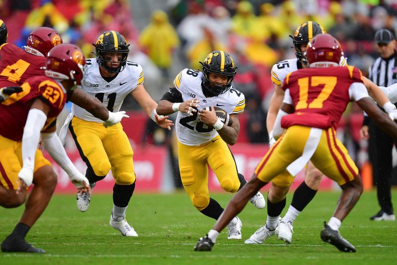 Nov 15, 2025; Los Angeles, California, USA; Iowa Hawkeyes running back Kamari Moulton (28) runs the ball against the Southern California Trojans during the first half at the Los Angeles Memorial Coliseum. Mandatory Credit: Gary A. Vasquez-Imagn Images