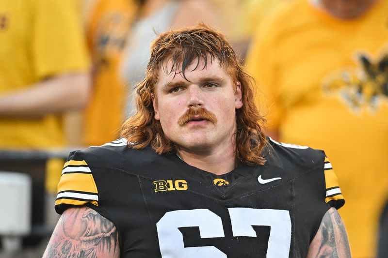 Sep 13, 2025; Iowa City, Iowa, USA; Iowa Hawkeyes offensive lineman Gennings Dunker (67) looks on before the game against the Massachusetts Minutemen at Kinnick Stadium. Mandatory Credit: Jeffrey Becker-Imagn Images