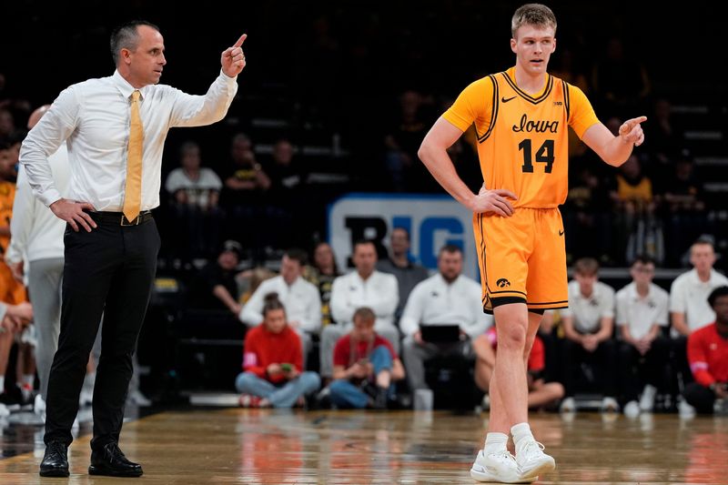 Iowa head coach Ben McCollum talks to Iowa guard Bennett Stirtz (14) during a basketball game against the Southeast Missouri Red Hawks Nov. 18, 2025 at Carver-Hawkeye Arena in Iowa City, Iowa.