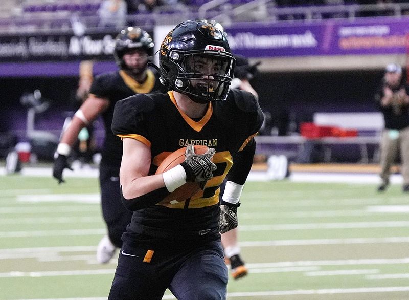 Bishop Garrigan sophomore CJ McGregor (22) runs for a touchdown against Woodbine during the 8-players state championship on Nov. 20, at the UNI Dome in Cedar Falls.
