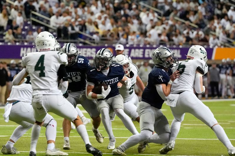 Xavier's Carter Hoffmann (1) carries the ball against the Pella Dutch Nov. 20, 2025 during the Class 4A state football championship at the UNI-Dome in Cedar Falls, Iowa.