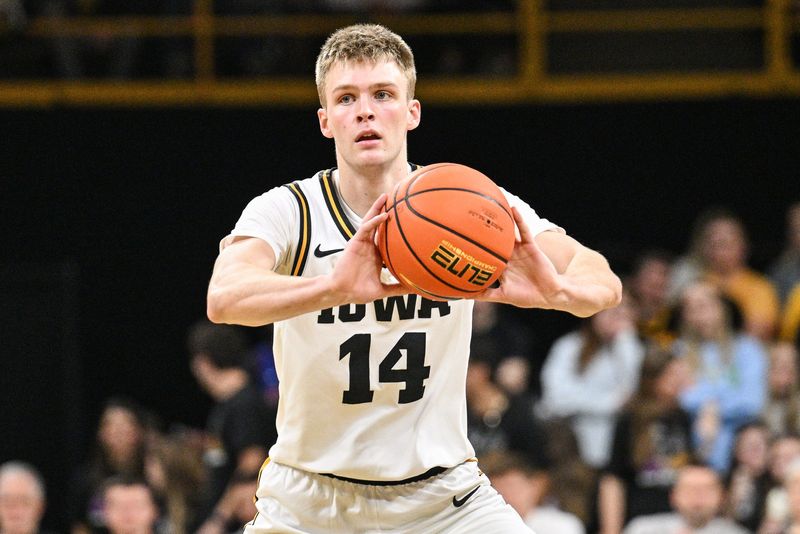 Nov 20, 2025; Iowa City, Iowa, USA; Iowa Hawkeyes guard Bennett Stirtz (14) passes the ball against the Chicago State Cougars during the second half at Carver-Hawkeye Arena. Mandatory Credit: Jeffrey Becker-Imagn Images