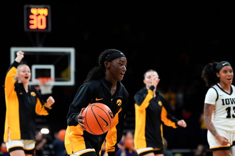 Iowa guard Chit-Chat Wright (11) dribbles the ball as the Hawkeys run out on the court Oct. 30, 2025 before an exhibition game against the Ashland Eagles at Carver-Hawkeye Arena in Iowa City, Iowa.