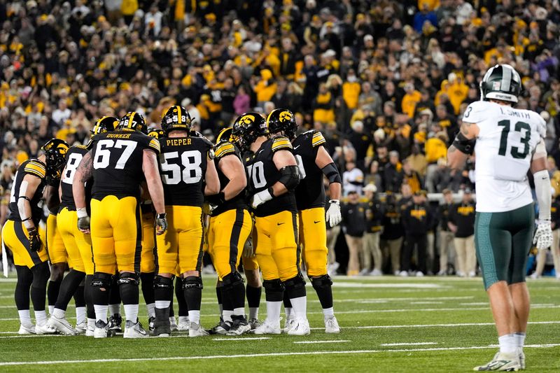 The Iowa Hawkeyes huddles in the redzone against the Michigan State Spartans Nov. 22, 2025 at Kinnick Stadium in Iowa City, Iowa.