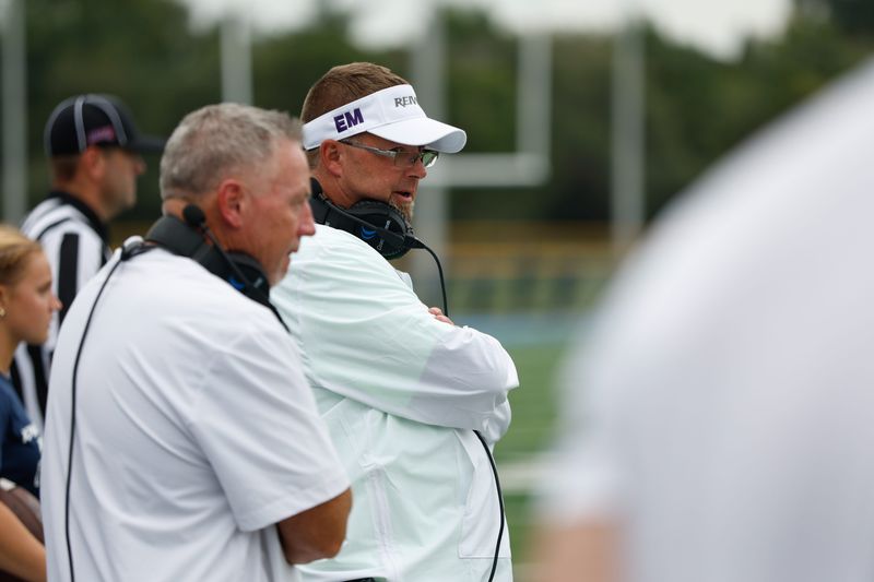 Iowa Western football coach Scott Strohmeier has been wearing a visor with "EM" printed on it, honoring his late daughter Emily Strohmeier.