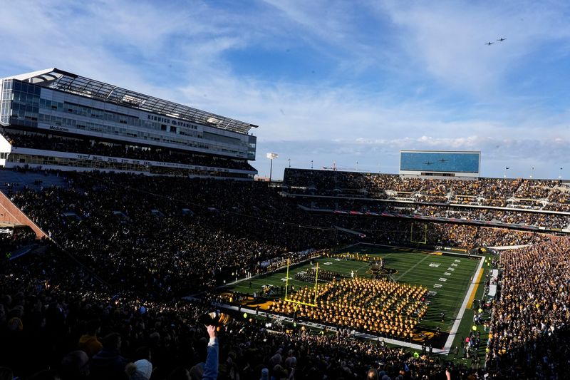 Fans watch a military flyover during the National Anthem before kickoff between Iowa football and Michigan State Nov. 22, 2025 at Kinnick Stadium in Iowa City, Iowa.
