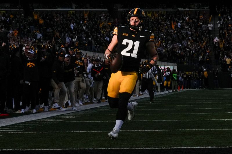 Iowa Hawkeyes wide receiver Kaden Wetjen (21) returns a punt to the endzone against the Michigan State Spartans on Nov. 22, 2025, at Kinnick Stadium in Iowa City, Iowa.