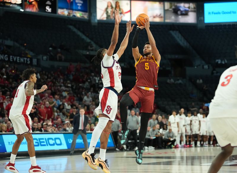 Nov 24, 2025; Las Vegas, Nevada, USA; Iowa State Cyclones forward Joshua Jefferson (5) shoots a attempts a three-point basket over St. John's Red Storm forward Bryce Hopkins (23) during the second half in a 2025 Players Era Festival group play game at Michelob Ultra Arena. Mandatory Credit: Kirby Lee-Imagn Images