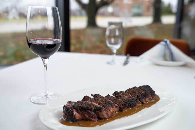 A steak and a glass of red wine at Prime and Providence on Tuesday, Nov. 25, 2025, in West Des Moines.