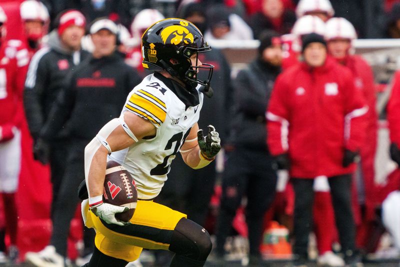 Nov 28, 2025; Lincoln, Nebraska, USA; Iowa Hawkeyes wide receiver Kaden Wetjen (21) runs against the Nebraska Cornhuskers during the third quarter at Memorial Stadium. Mandatory Credit: Dylan Widger-Imagn Images