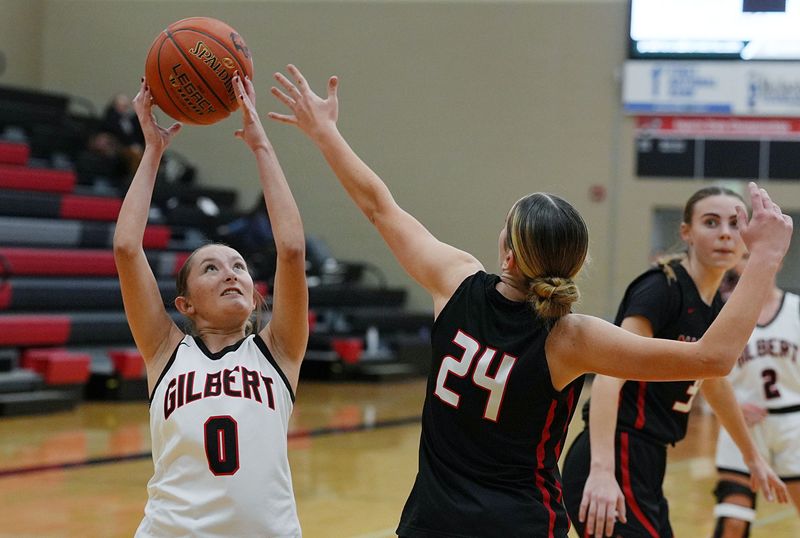Gilbert guard Izzy Terrones (0) beats Mason City's Anna Latham (24) for a rebound during the second quarter of the Tiger girls basketball team's game against the Riverhawks on Dec. 1, 2025, at the Gilbert High School gym in Gilbert, Iowa.