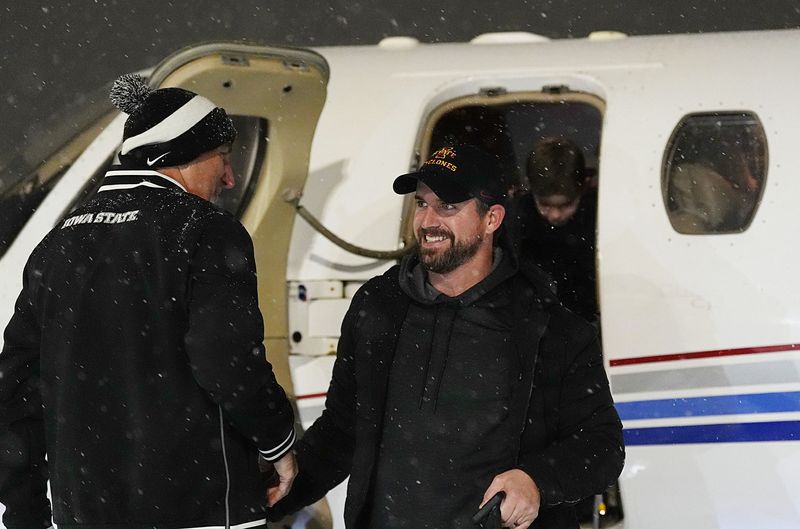Iowa State's new football coach Jimmy Rogers, right, is greeted by athletics director Jamie Pollard after arriving at Ames Municipal Airport on Dec. 6, 2025, in Ames, Iowa.