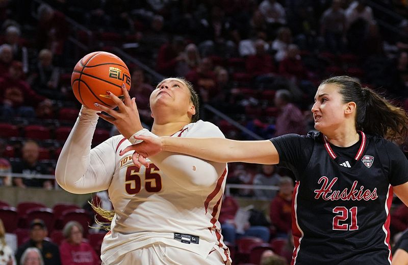 Iowa State Cyclones' center Audi Crooks (55) shoots the ball around Northern Illinois Huskies forward Marta Hermoso (21) during the first quarter in the NCAA women basketball non-conference game on Dec. 7, 2025, at Hilton Coliseum in Ames, Iowa.