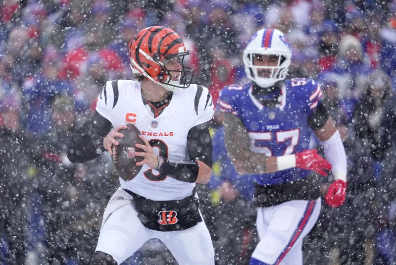 Cincinnati Bengals quarterback Joe Burrow runs away from Buffalo Bills defensive end AJ Epenesa and gets off a pass during first half action at Highmark Stadium in Orchard Park on Dec. 7, 2025.