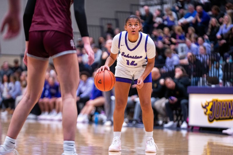 Johnston's Arianna Phillips (14) watches the clock as time winds down in the first half against Dowling Catholic on Dec. 16, 2025, at Johnston High School.