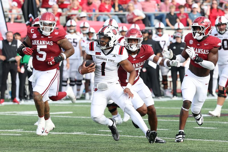 Arkansas State Red Wolves quarterback Jaylen Raynor (1) rushes in the second quarter against the Arkansas Razorbacks at War Memorial Stadium in Little Rock, Arkansas.
