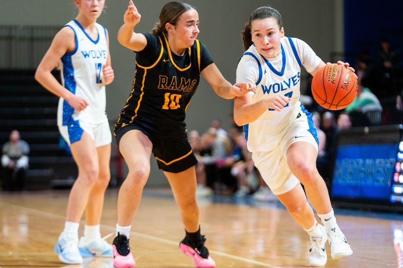 Northwest’s Romey Croatt (32) drives past her defender, Southeast Polk's Ella Wheatly (10), on Dec. 19, 2025, at Waukee Northwest High School.