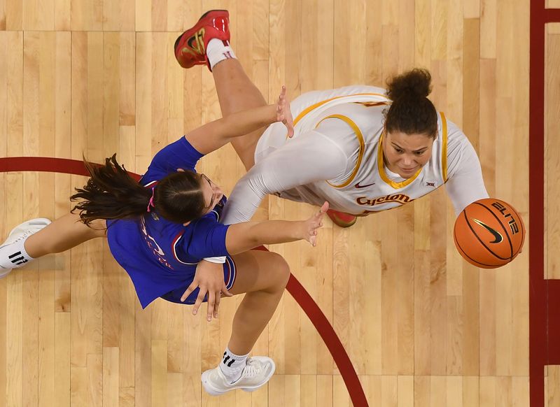 Iowa State Cyclones' center Audi Crooks (55) shoots the ball around Kansas Jayhawks forward Lilly Meister (52) during the first quarter in the Big-12 conference home opener on Dec. 21, 2025, at Hilton Coliseum in Ames, Iowa.