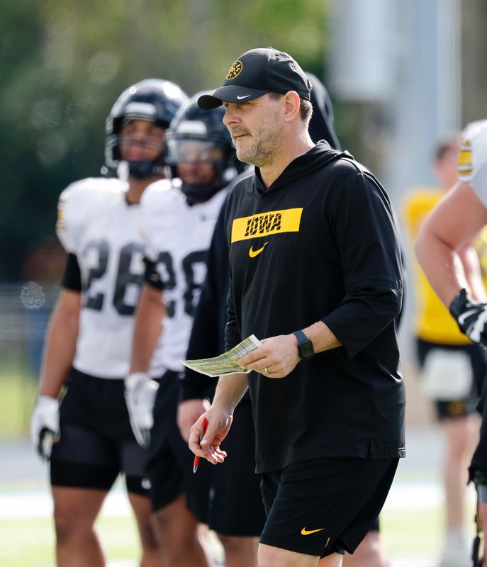 Iowa football offensive coordinator Tim Lester watches practice on Dec. 27 ahead of the ReliaQuest Bowl against Vanderbilt.